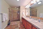 The master bath has a large step in shower and double sinks.